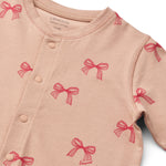 Liewood Piżama dla dziecka jednoczęściowa Birk Grow Printed Bows / Pale tuscany