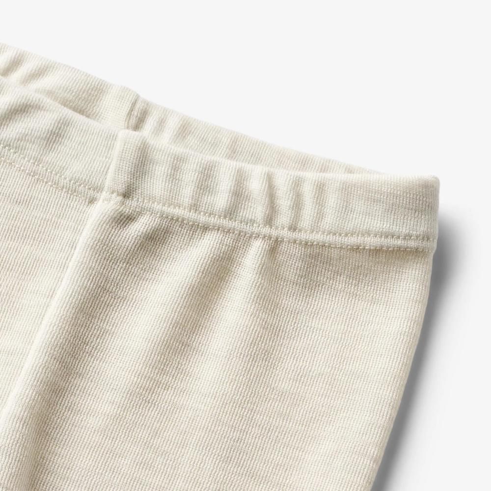 Wheat wełniane legginsy dziecięce Agi eggshell melange