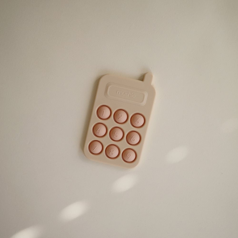 Mushie Zabawka sensoryczna Bąbelki do wciskania telefon Blush