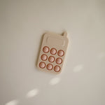 Mushie Zabawka sensoryczna Bąbelki do wciskania telefon Blush
